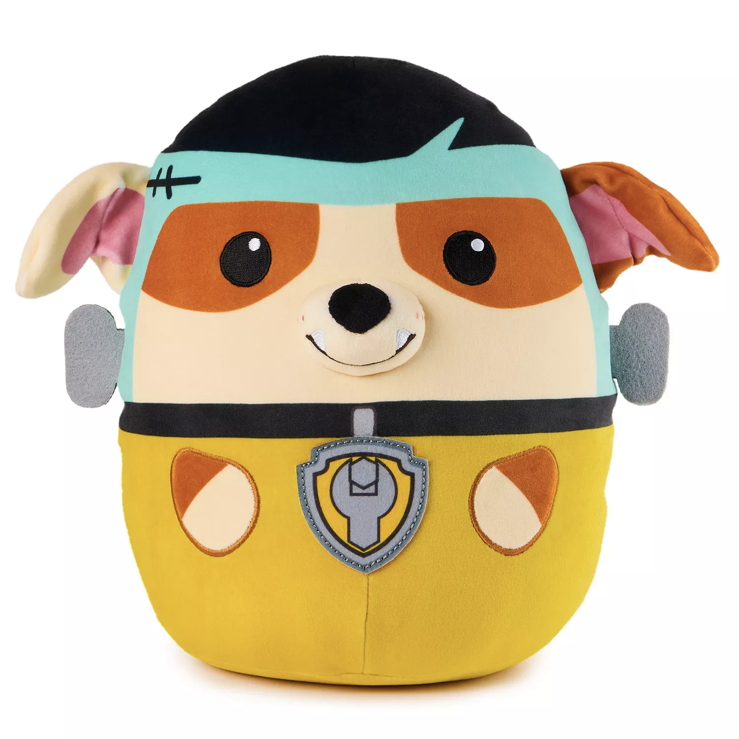 A plush toy depicting a dog character dressed as a superhero, featuring a yellow outfit, a blue mask, and a badge emblem.