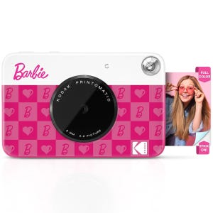 Kodak x Barbie Digital Camera features a pink checkerboard design with hearts and the letter \“B,\“ includes a round lens, and has the ability to print full-color stick-on photos instantly.