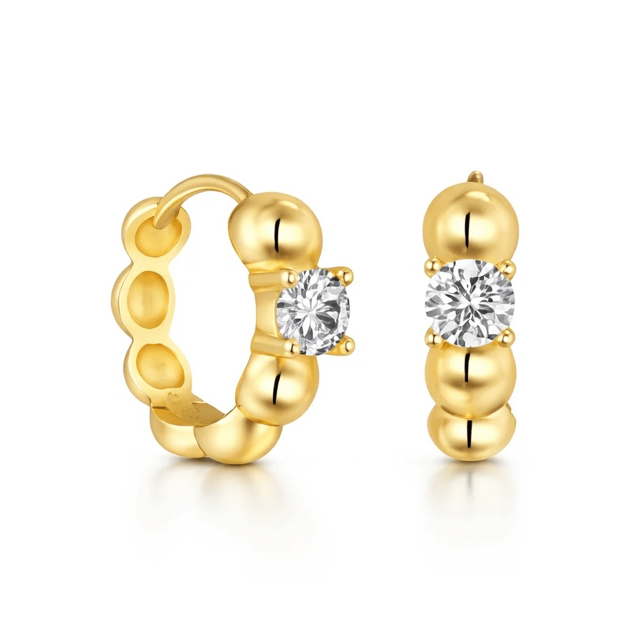 Gold hoop earrings with a beaded design, featuring round, clear gemstones set at the center.