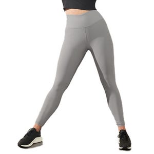 A person wearing gray leggings and black sneakers.