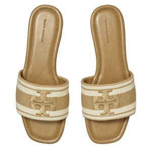 Tan slide sandals with a cushioned footbed, featuring a textured strap with the Tory Burch Double T logo in a lighter shade.