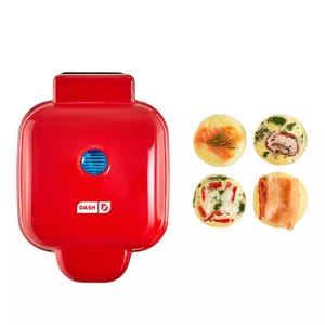 Red Dash egg bite maker with four different egg bites featuring various fillings like salmon, mushroom, and bacon.