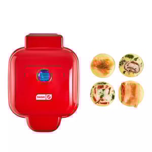Red Dash egg bite maker with four different egg bites featuring various fillings like salmon, mushroom, and bacon.