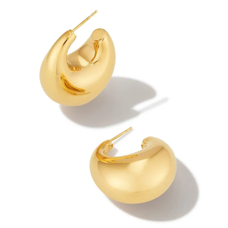 Kendra Scott 18K Raylyn Hoop Earrings are chunky, polished gold hoops with a curved, crescent-like design, featuring a simple post-back closure.