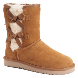 Koolaburra by UGG Short Victoria Boots feature a chestnut suede exterior, shearling lining, and decorative bows on the back with a rubber sole for traction.