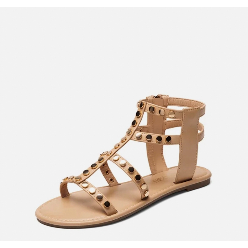 A beige sandal with studded straps and a back ankle support.