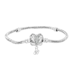 A silver bracelet features a butterfly charm adorned with small gemstones and a dangling element, attached to a sleek, snake chain design.