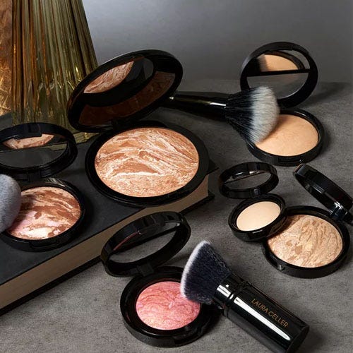 a collection of cosmetics on a grey background