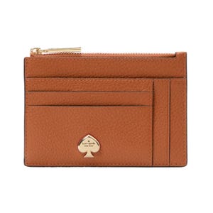 A brown leather cardholder with multiple slots and a gold zipper, featuring a spade-shaped logo that reads \“kate spade new york.\“
