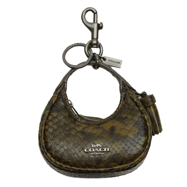 A small Coach keychain with a brown and yellow snake print design, featuring a clasp and a mini bag shape with a Coach logo and a tassel.