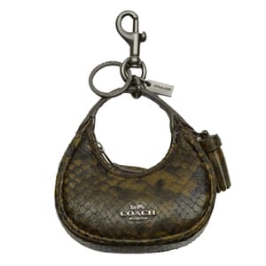 A small Coach keychain with a brown and yellow snake print design, featuring a clasp and a mini bag shape with a Coach logo and a tassel.