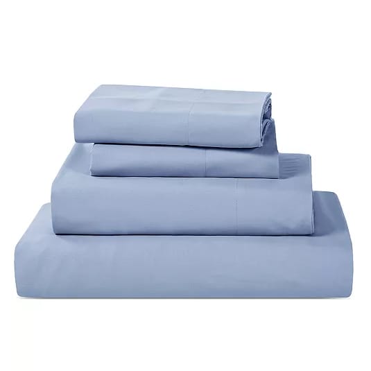 A neatly stacked set of light blue bedsheets and pillowcases.
