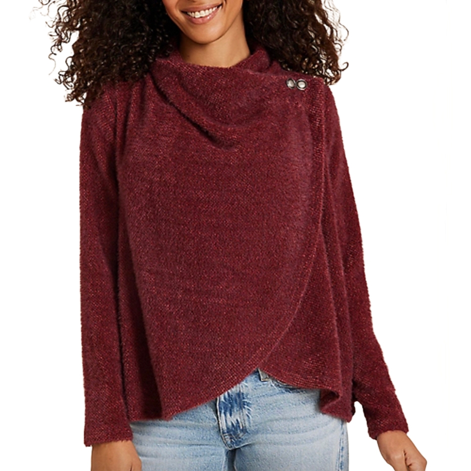 A long-sleeve, deep red asymmetrical cardigan with a draped neckline and overlapping front design, featuring button accents on the shoulder, paired with light blue jeans.