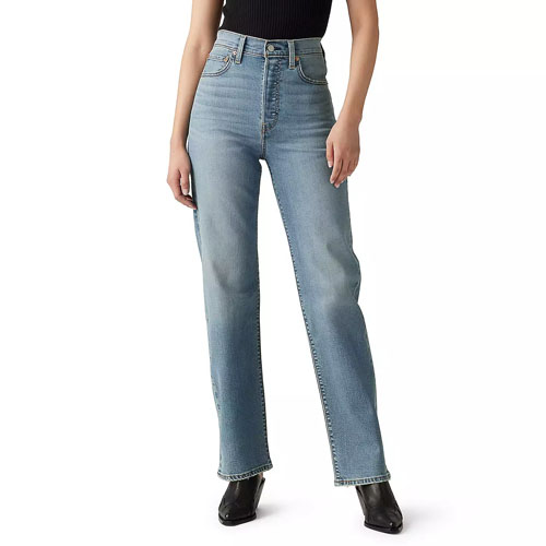 A person is wearing high-waisted, light blue straight-leg jeans paired with a black top and black shoes.