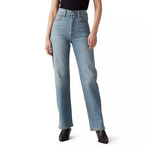 A person is wearing high-waisted, light blue straight-leg jeans paired with a black top and black shoes.