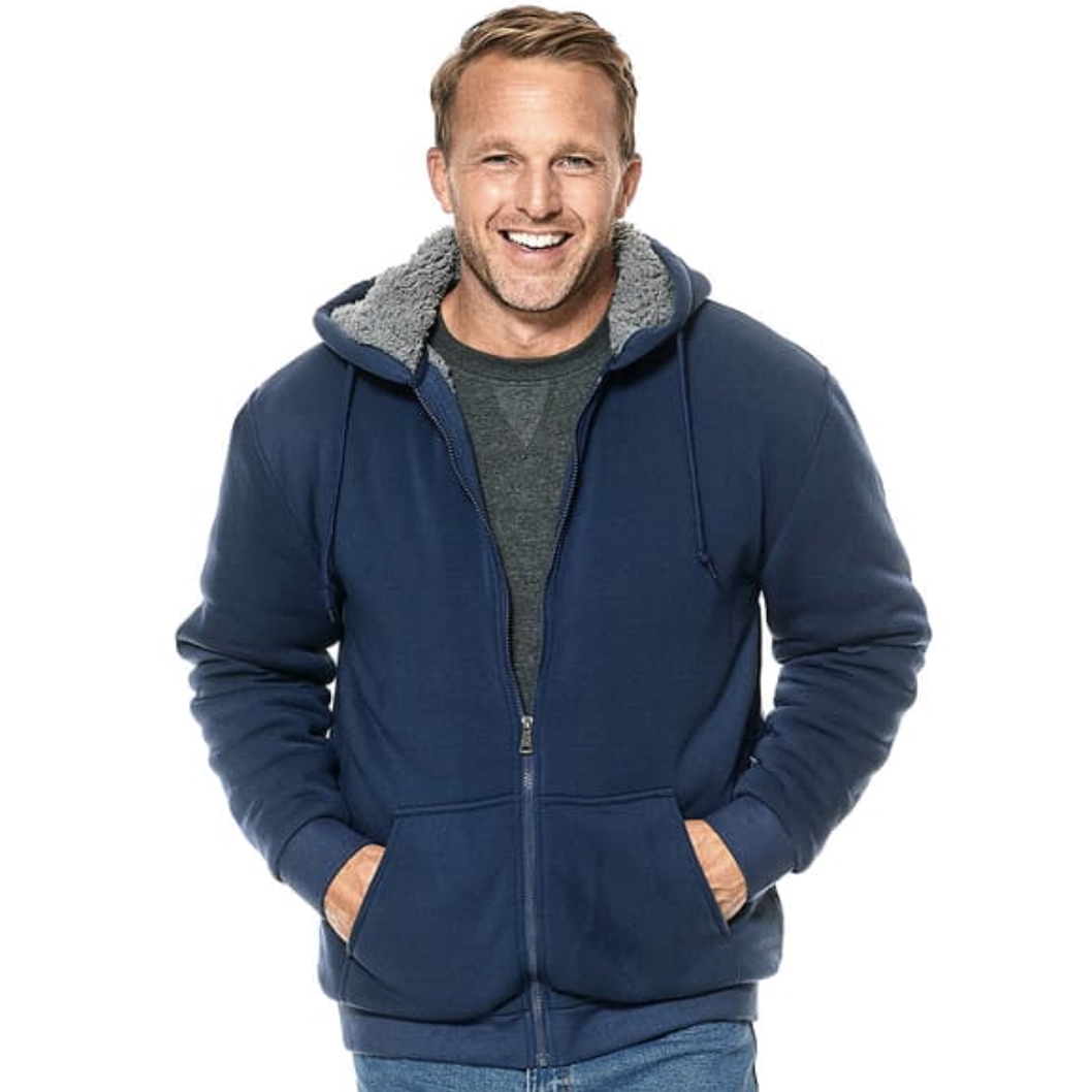 A man wears a navy blue Sherpa-lined hooded jacket with a front zipper and pockets, providing warmth and comfort.