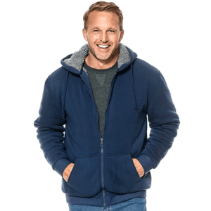 A man wears a navy blue Sherpa-lined hooded jacket with a front zipper and pockets, providing warmth and comfort.