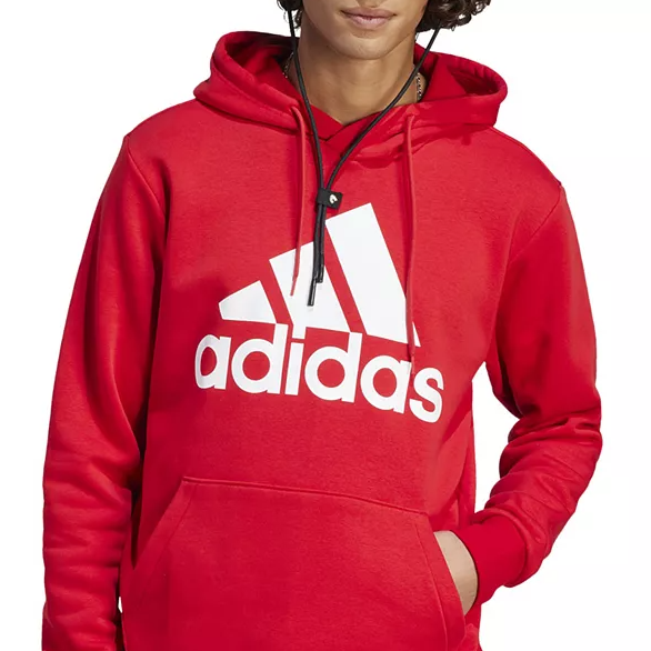A person wearing a red Adidas hoodie featuring the brand's logo in white across the chest.