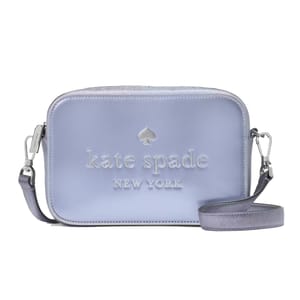 A pale blue Kate Spade crossbody bag with a spade logo and brand name embossed.