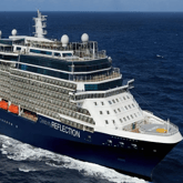 A large cruise ship named Celebrity Reflection is sailing on the ocean, featuring multiple decks, balconies, and visible lifeboats.