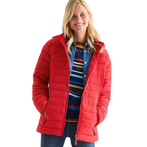 A person wearing a red quilted jacket over a blue shirt with multicolored stripes and denim jeans.