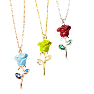 Three Custom Rose Birthstone Necklaces, each featuring a different colored rose—blue, green, and red—on gold or silver chains, with matching gemstone leaves as accents.