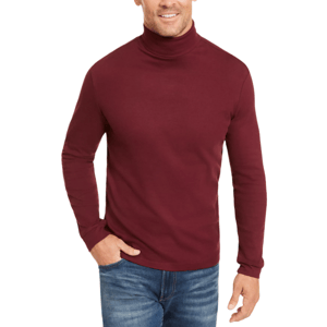 A man is wearing a burgundy long-sleeve turtleneck and blue jeans.