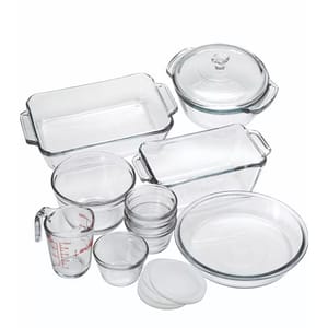 A 15-piece set of clear glass Anchor Hocking bakeware, including various sizes of mixing bowls, measuring cup, casserole dishes with lids, and loaf pan.