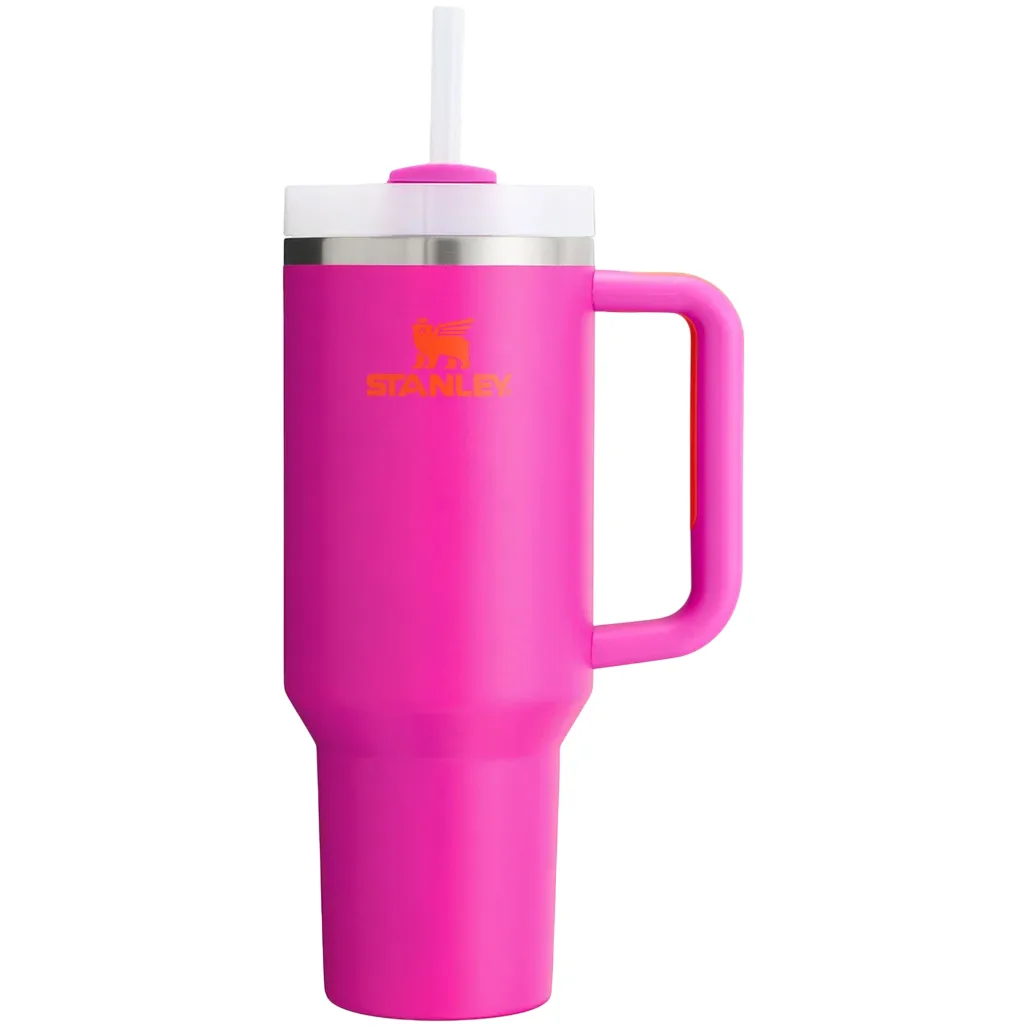 Pink Stanley cup with a handle, white lid, and straw, featuring an orange logo.