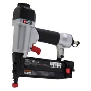 A Porter-Cable pneumatic nailer with a black and gray body, featuring a red trigger and designed for use with various fasteners.