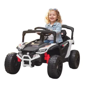 A child is driving a black and white toy ride-on car down a cobblestone path surrounded by vibrant flowers in a garden setting.