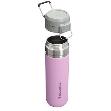 A pink stainless steel Stanley water bottle with an attached lid.