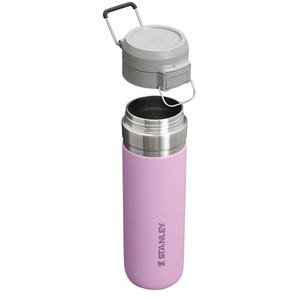 A pink stainless steel Stanley water bottle with an attached lid.