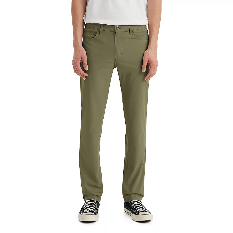 Levi's 511 Slim Tech Pants in olive color feature a slim fit design with a classic 5-pocket style, belt loops, and a button-zip closure, paired with black and white sneakers.
