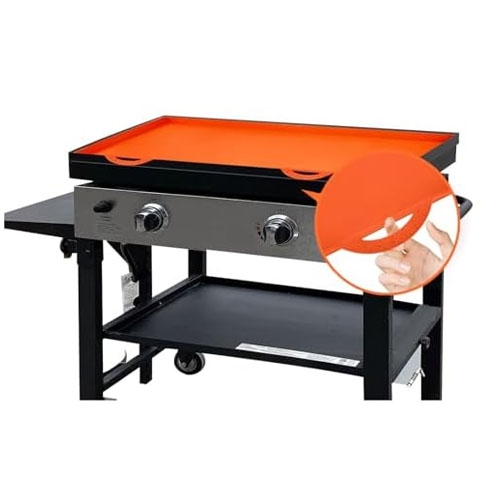 A griddle cover, shown in orange silicone, fits a double-burner outdoor griddle with a black and stainless steel design.