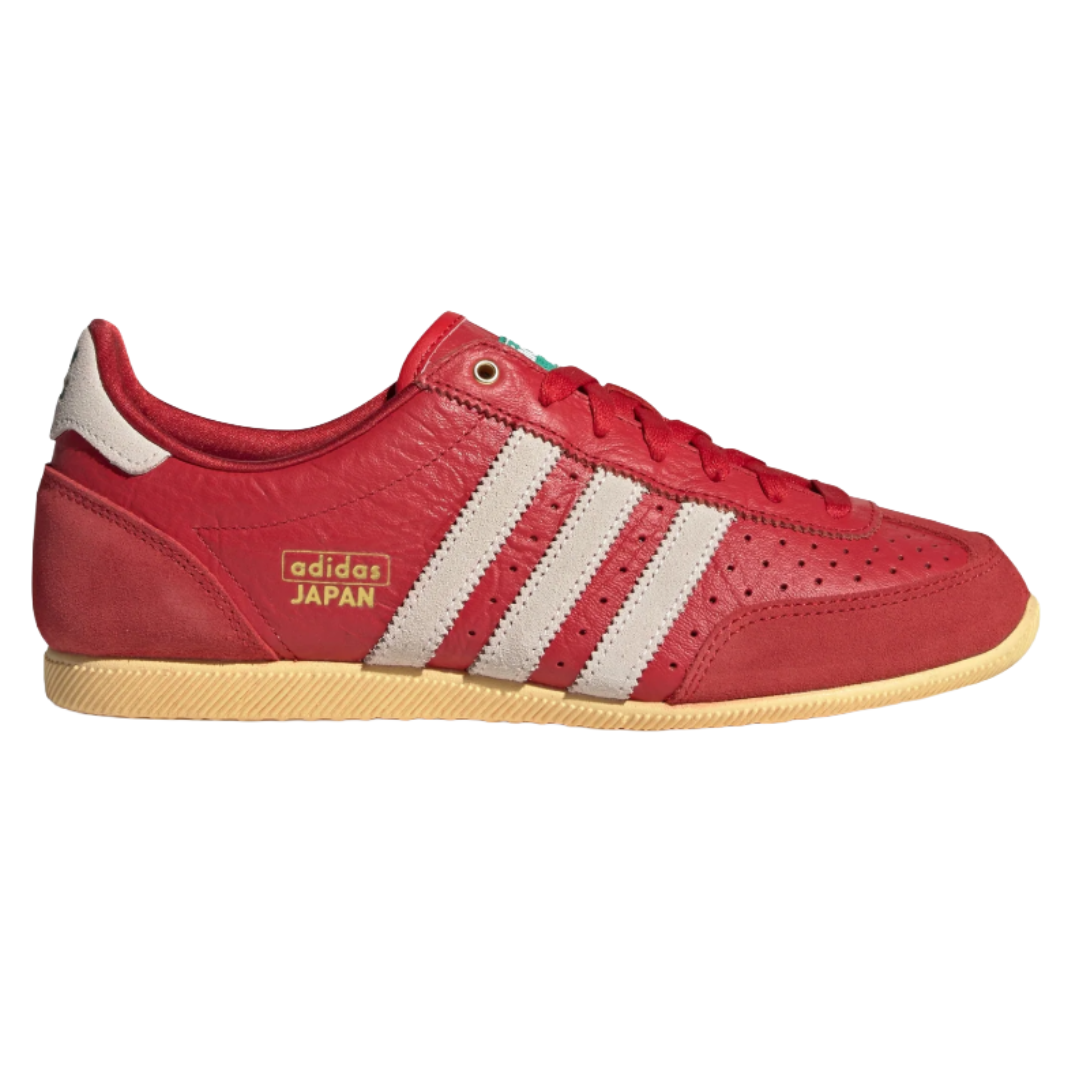 Red Adidas Japan sneakers with white stripes and a beige sole, featuring the text \“adidas JAPAN\“ in gold on the side.