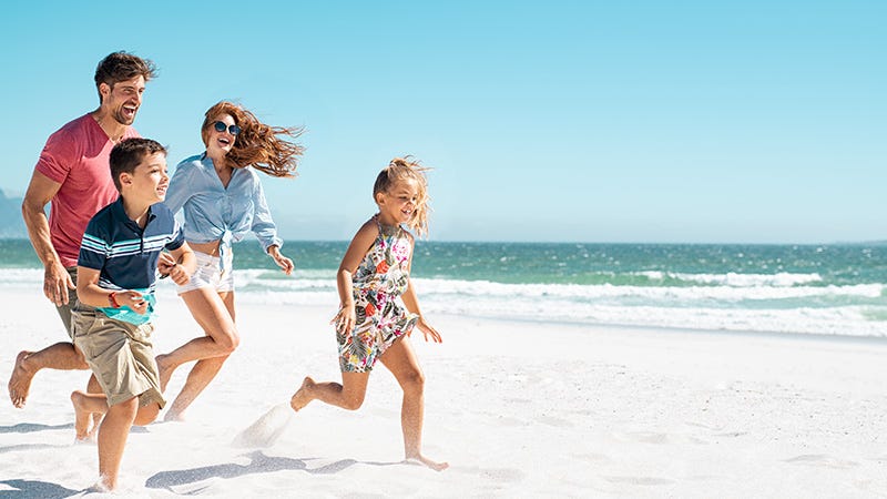 family running on the beach