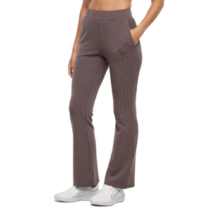 Brown flared ribbed pants with an elastic waistband and side pockets, paired with white sneakers.