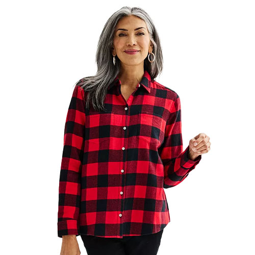 A woman is wearing a red and black checked flannel shirt with long sleeves, a collar, and button-down front.