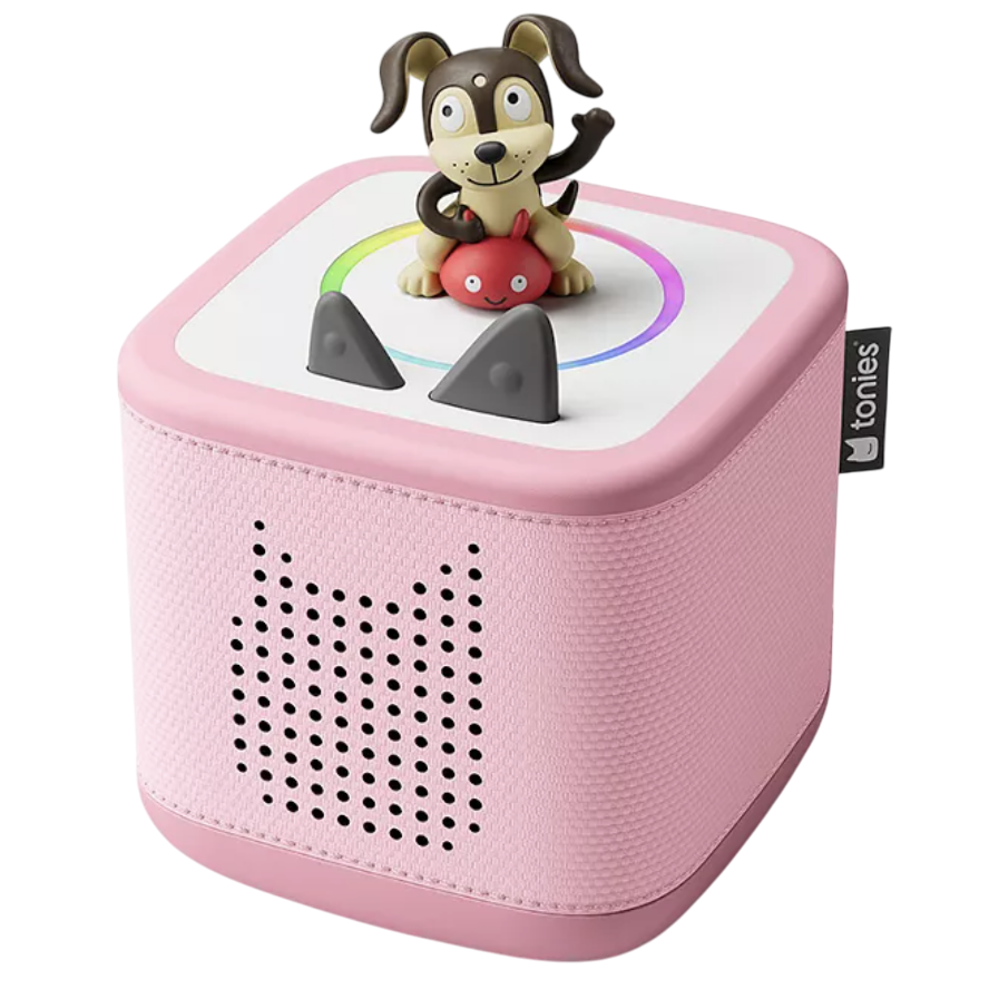 A pink Toniebox audio player with a dog figurine on top, designed for playing interactive audio stories for children.