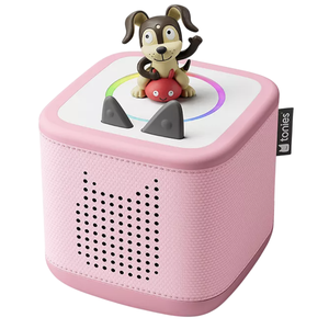 A pink Toniebox audio player with a dog figurine on top, designed for playing interactive audio stories for children.
