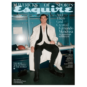 A person is seated in a locker room wearing a white coat and black pants, surrounded by sports equipment. The magazine cover text reads \“Mavericks of Sports\“ with headlines about various athletes and new hotels.