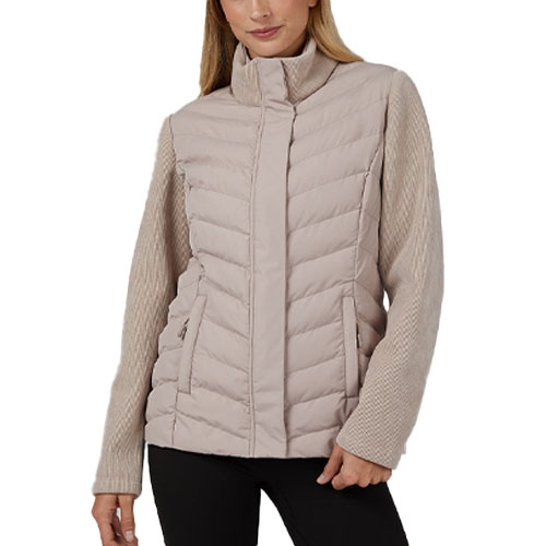 A beige quilted jacket with a high collar, featuring knit sleeves and zippered pockets, worn by a person dressed in black pants.