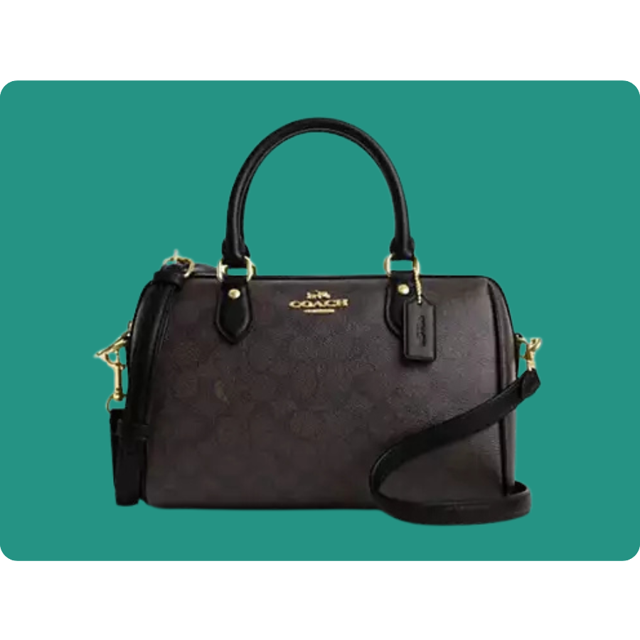 A black and brown Coach handbag with gold hardware, featuring dual handles and an adjustable shoulder strap.