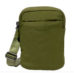 A compact, olive green crossbody bag with an adjustable strap and a zipper closure, branded with \“baggallini\“ on the front.