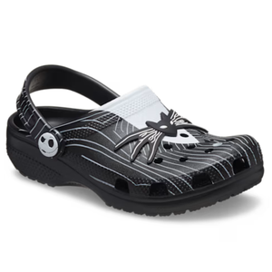 Black and white Crocs featuring a design inspired by \“The Nightmare Before Christmas,\“ with a spider web and character motifs.