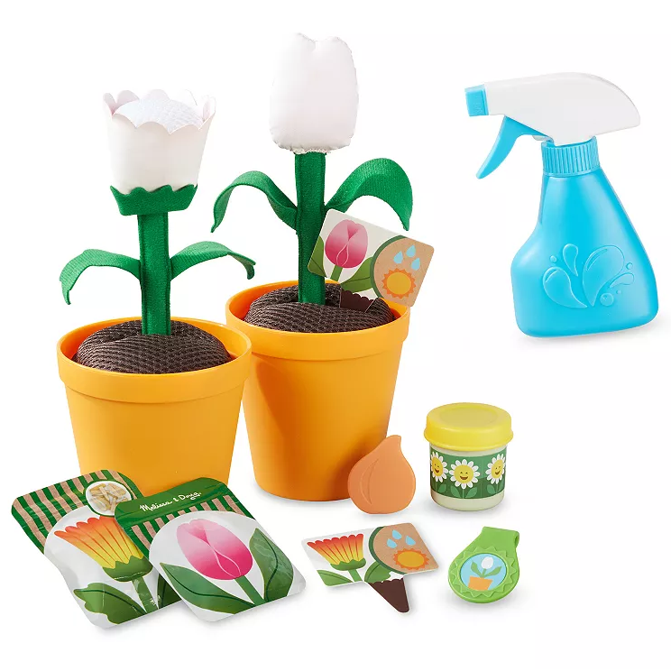 Toy gardening set with two flower pots, fabric flowers, seed packets, a blue spray bottle, and gardening accessories.