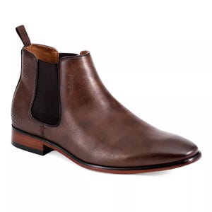 Tommy Hilfiger Men's Chelsea Dress Boots feature a sleek, smooth brown leather upper with a side elastic panel for easy slip-on access, a round toe, and a low stacked heel.