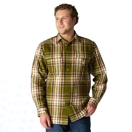 A man wearing a green plaid long-sleeve button-up shirt with a pocket on the left side, paired with blue jeans.