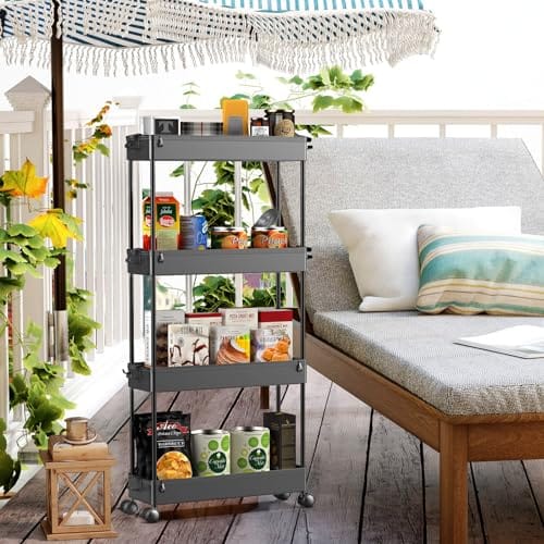A four-tier, gray utility cart with wheels is stocked with plant pots, books, and pantry items, positioned next to an outdoor lounge area.